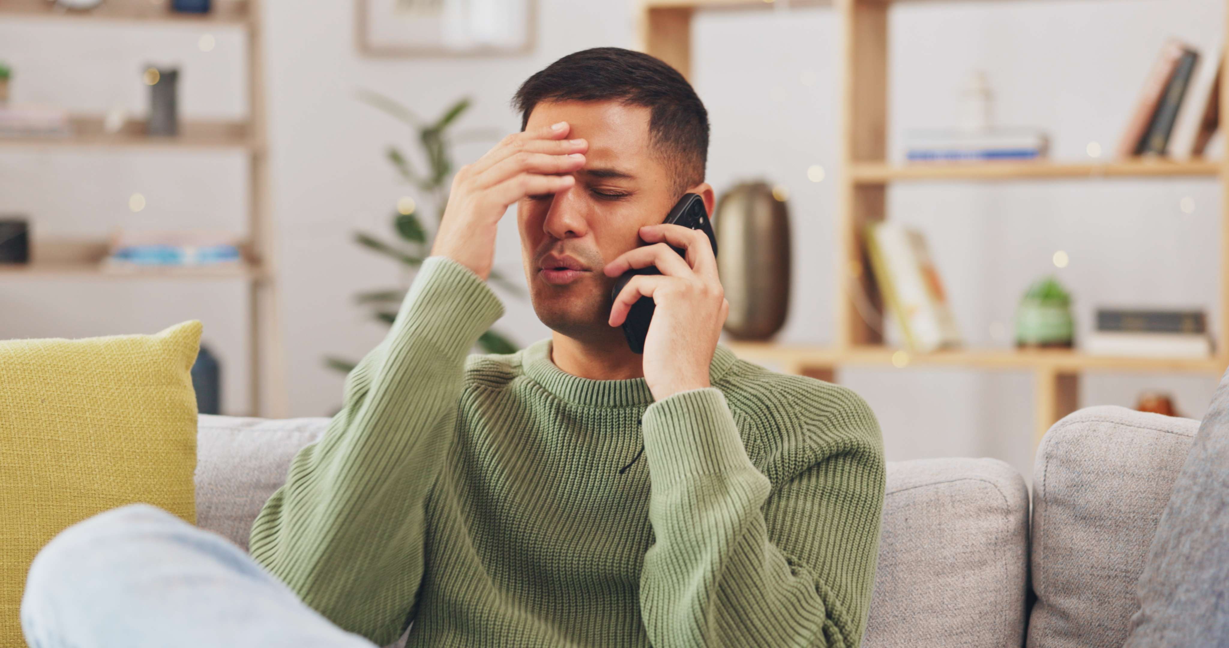 Man looking stressed while talking on his cell phone