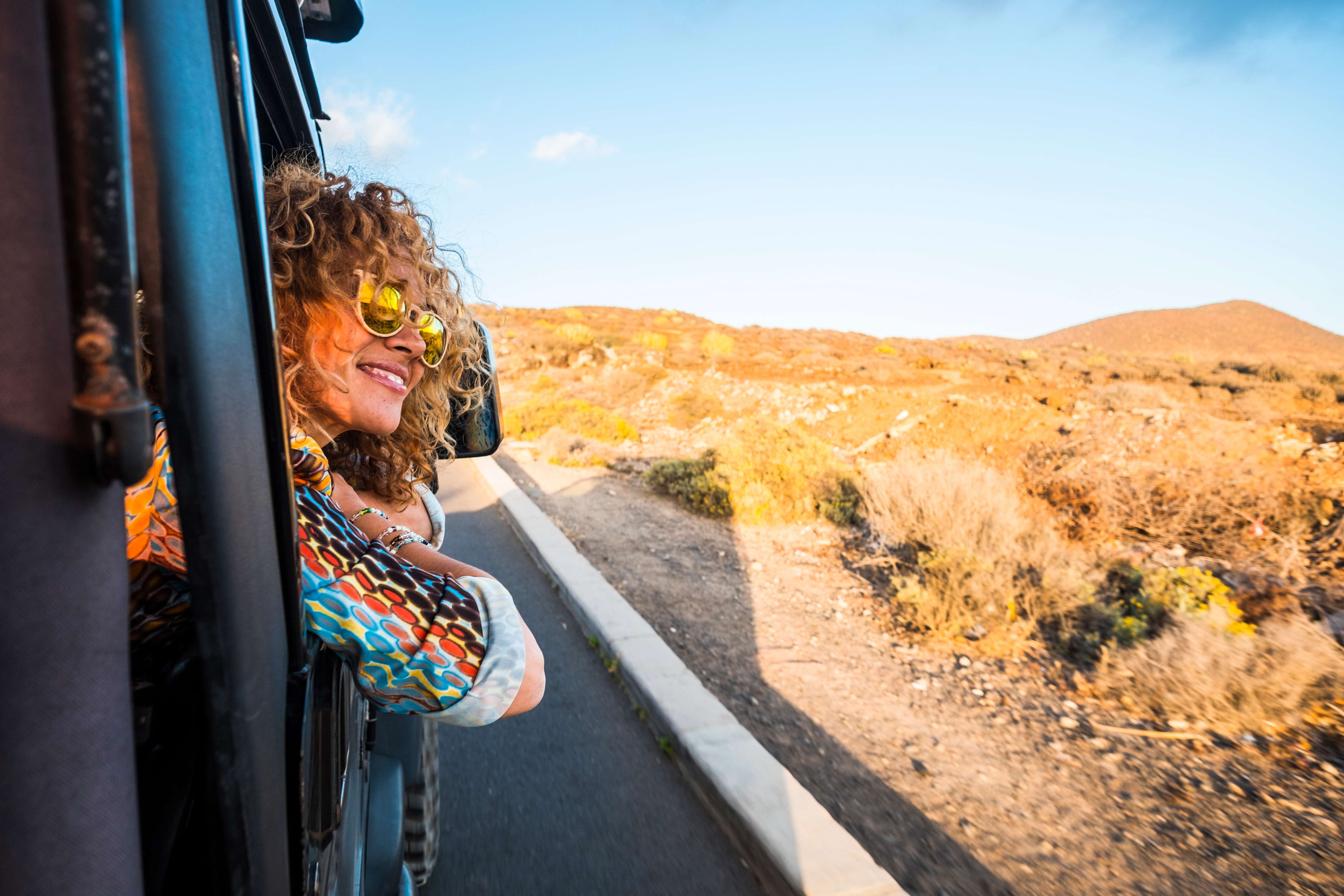 Woman traveling looking out window of vehicle