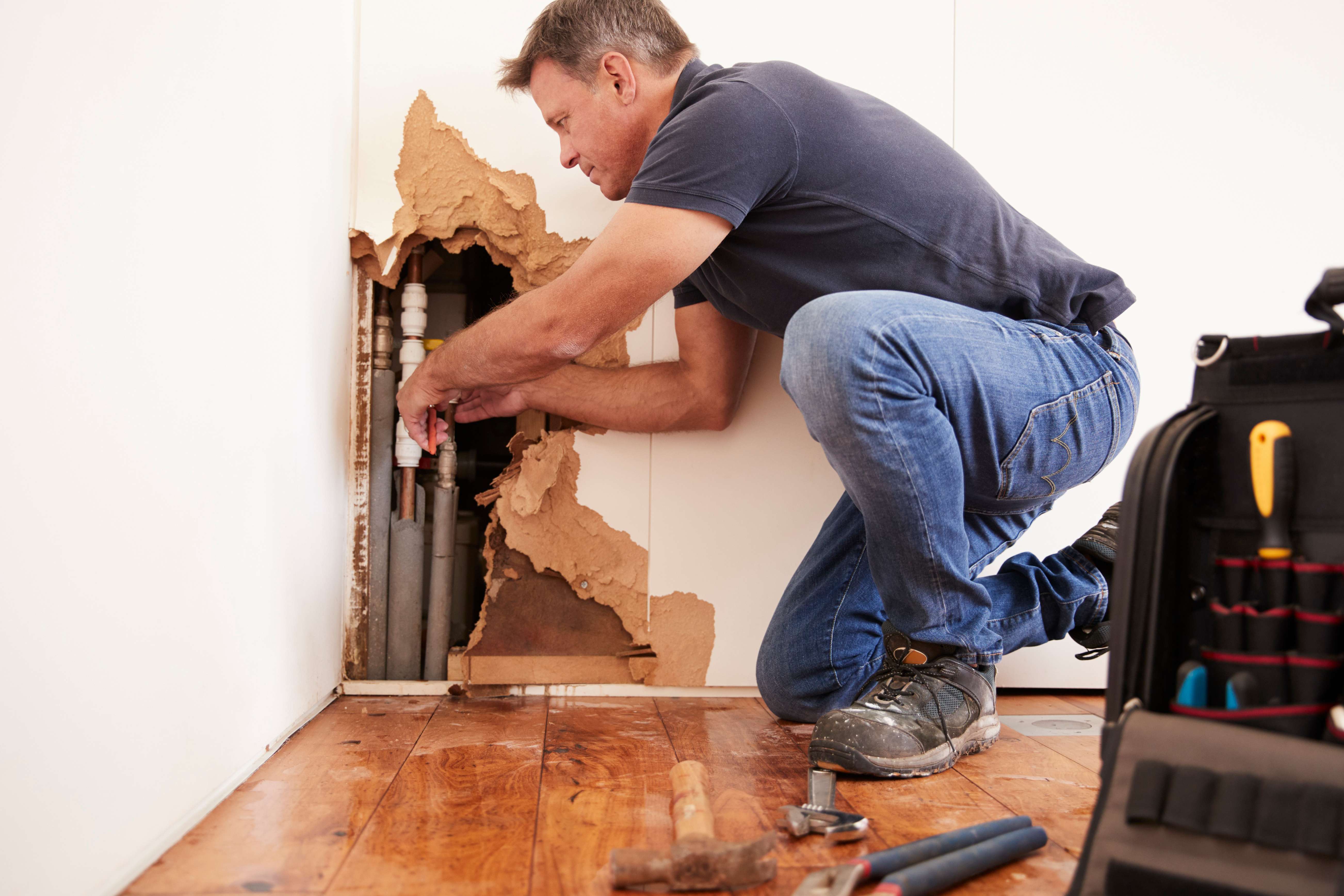 Man working on pipes in home