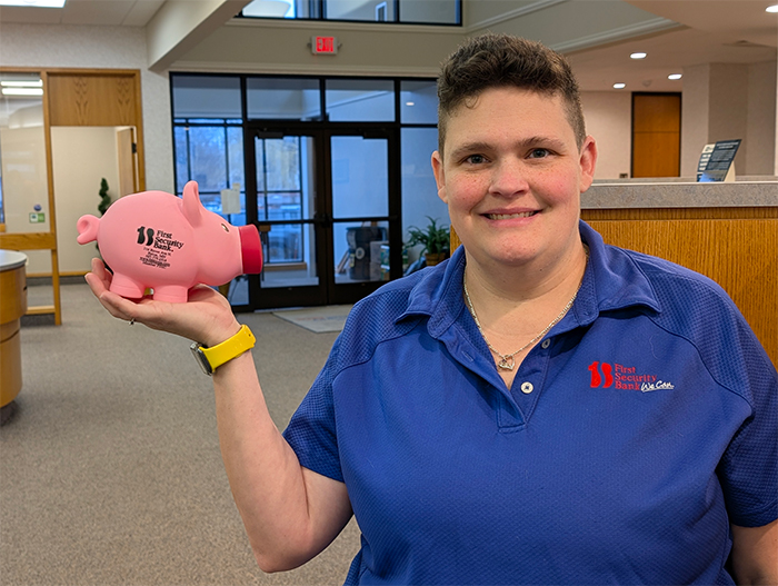 employee holding piggy bank